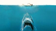Poster for the movie Jaws. Here we see the head of a great white shark underneath the blue water. Just above the shark is an unsuspecting swimmer.