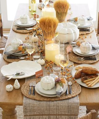 A thanksgiving table decorated with pumpkin ceramics and natural decor