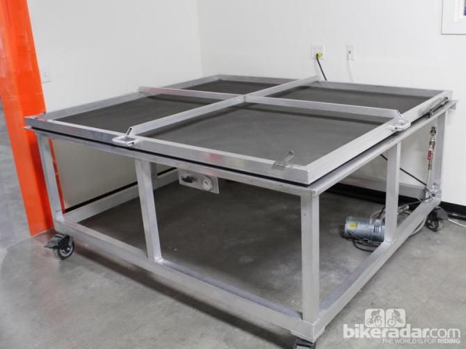 Stacks of carbon are compressed on this vacuum table before layup