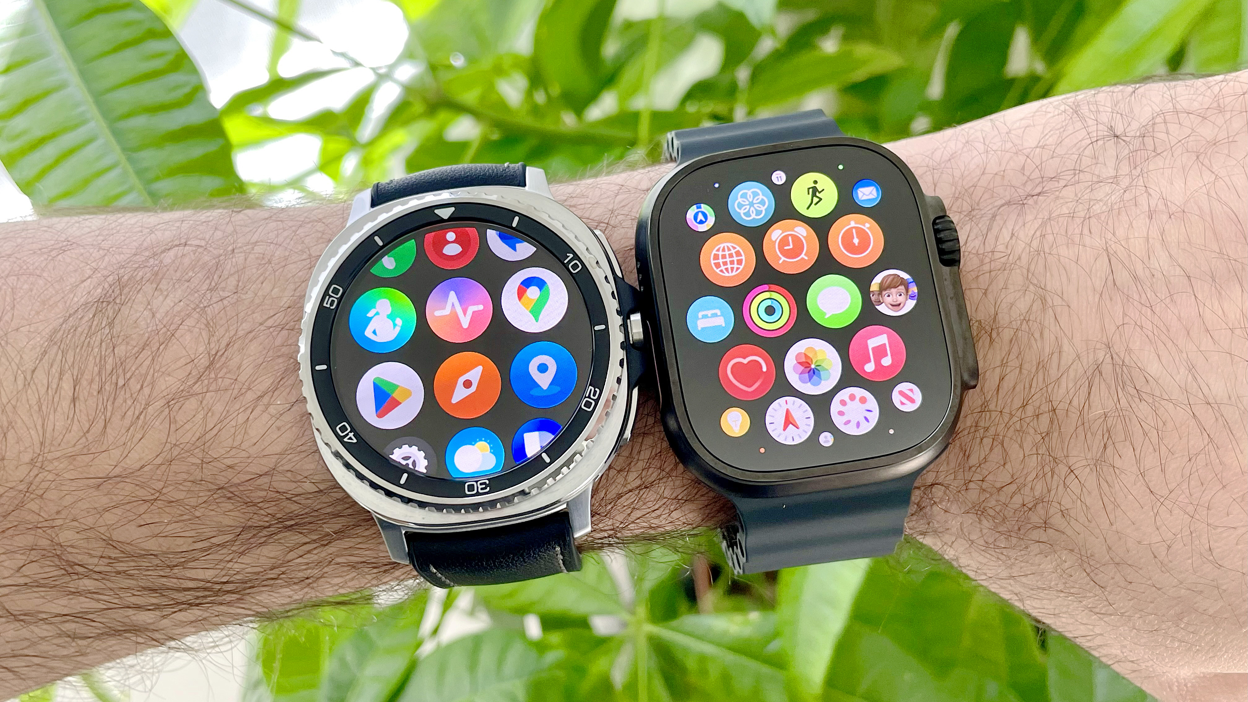 Close-up of a user's wrist wearing both the Samsung Galaxy Watch 8 Classic (left) and Apple Watch Ultra 2 in front of some green foliage