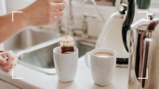 picture of woman taking out tea bag from mug