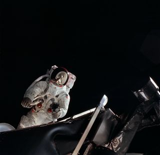 NASA astronaut Russell L. Schweickart during a spacewalk in March 1969, as seen from inside the lunar module.