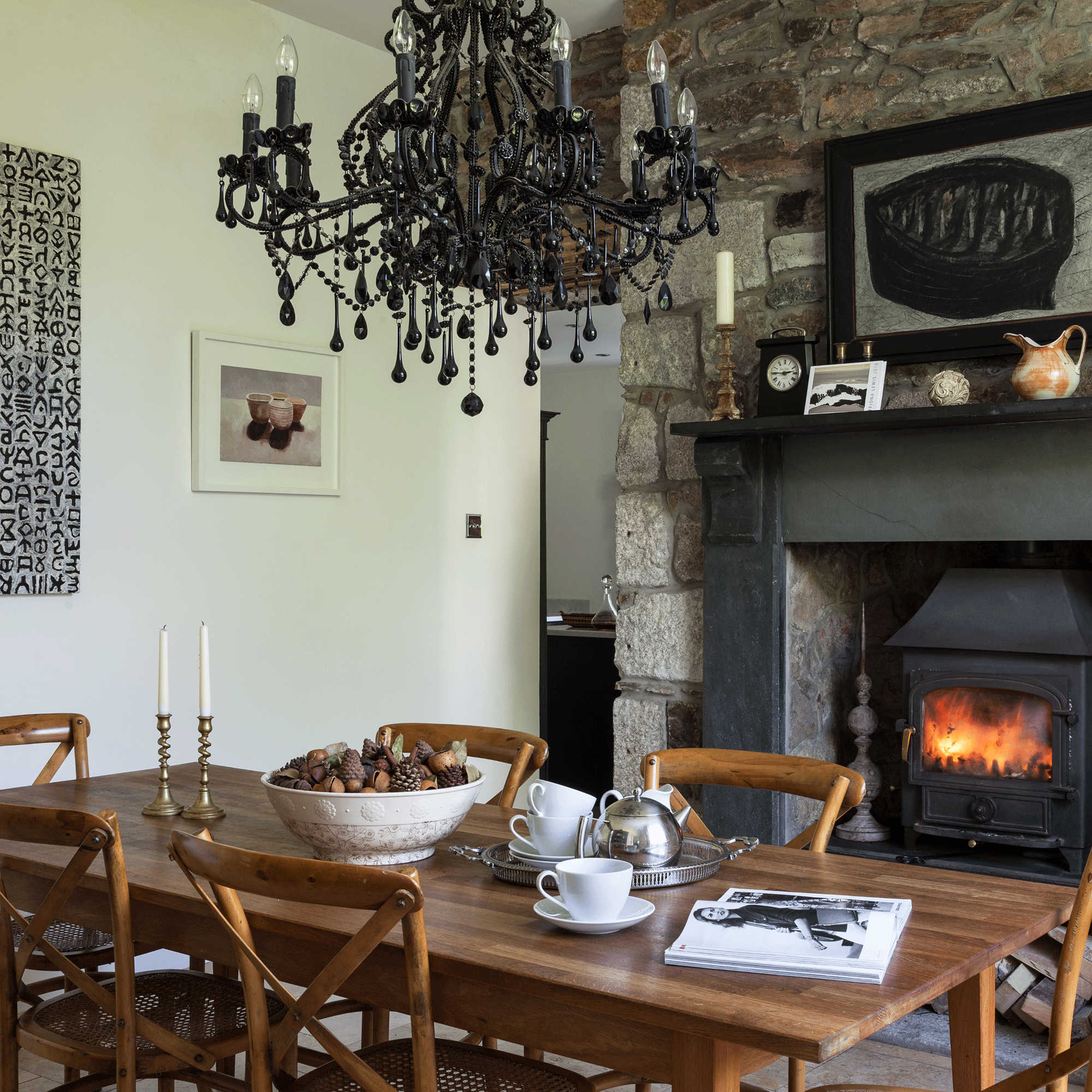 Black chandelier with wooden table