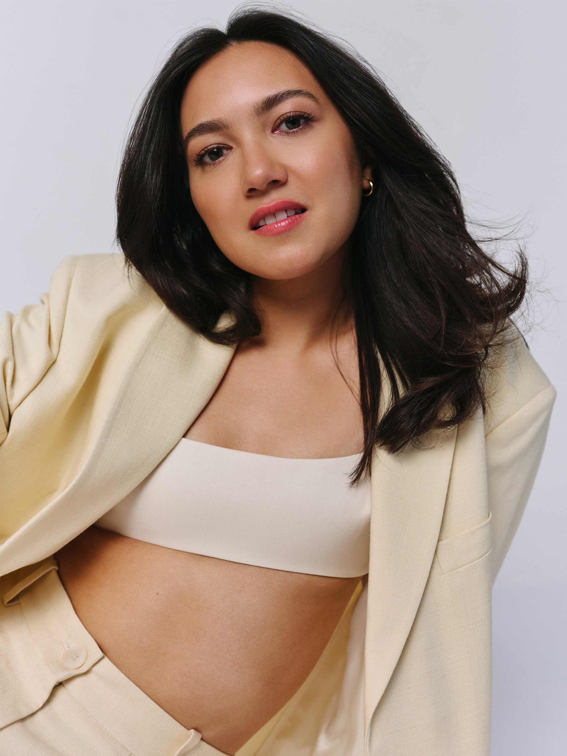 Rachel Marsh wearing a butter yellow suit with a white bralette.