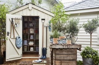 A painted garden shed with tools