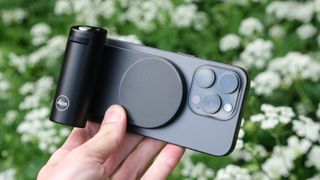 Leica Lux Grip attached to an iPhone and held in a hand