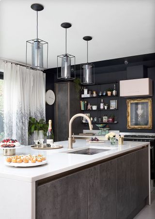 Concrete effect gray cabinets with a kitchen island with white counters and sink in a modern kitchen