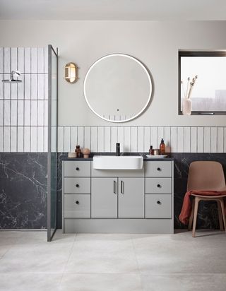 big and small bathroom tiles in contrast on wall