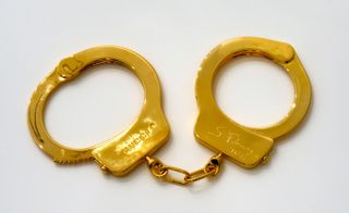 sculpture of gold handcuffs