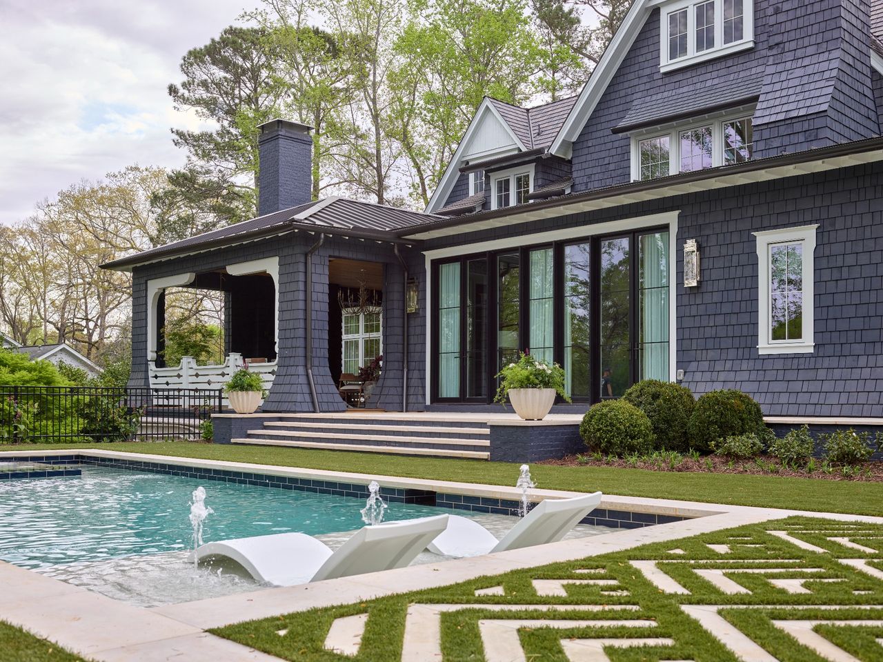 gray house overlooking a landscaped pool