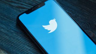 Twitter logo displayed connected  a smartphone