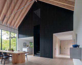 North Salem Farm by Worrell Yeung living space interior with dark feature wall