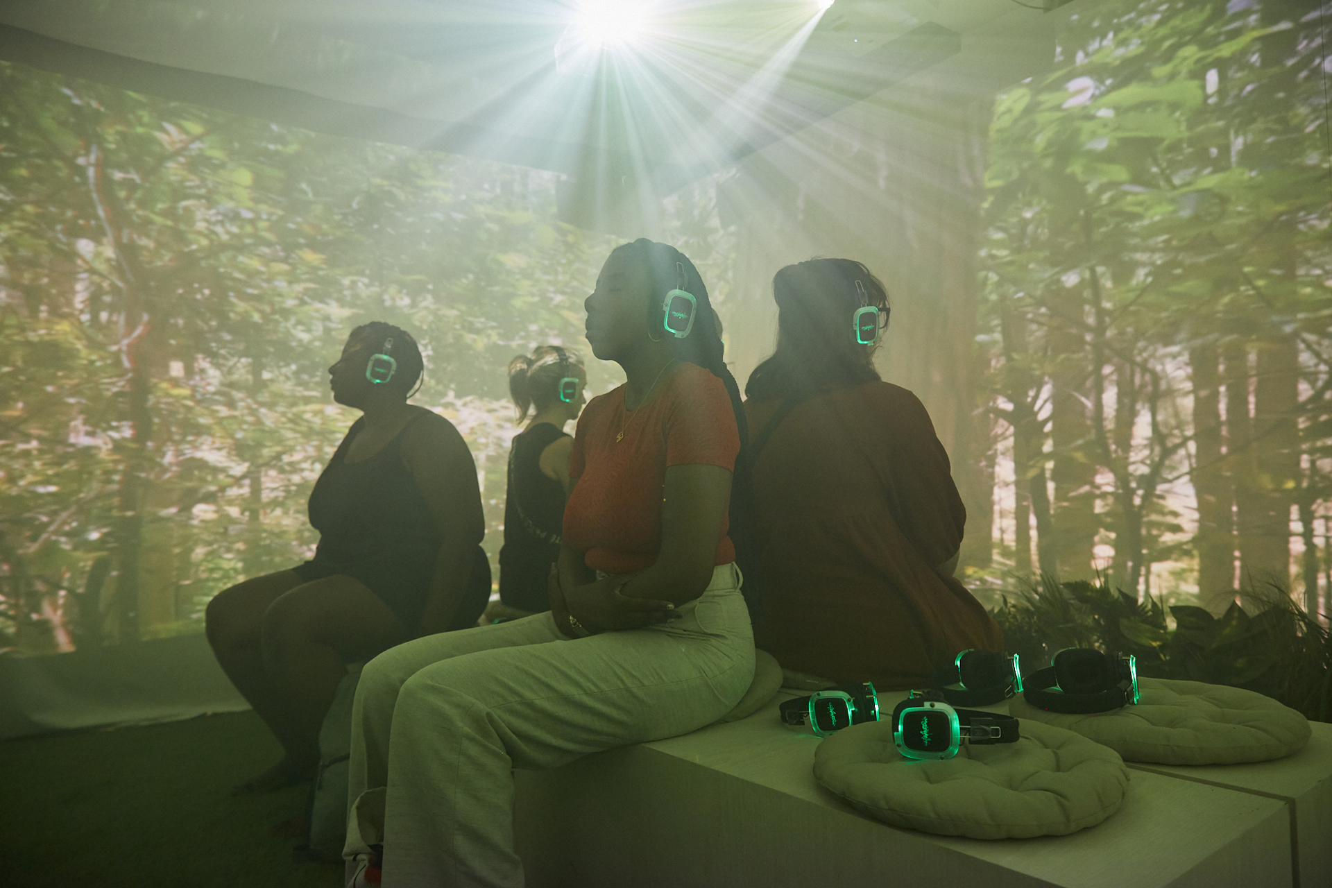themed popup with people sitting in what looks like a forest with headphones on