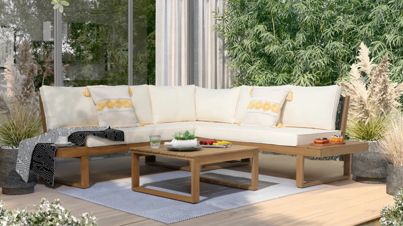 an outdoor seating area with an outdoor sectional and a small coffee table