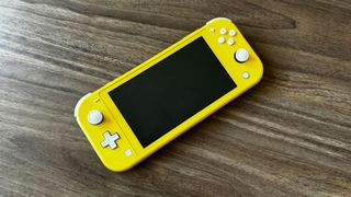 Yellow Nintendo Switch Lite on a wooden table