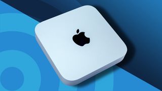 The Apple Mac Mini, top pick for best business computer, against a two tone background