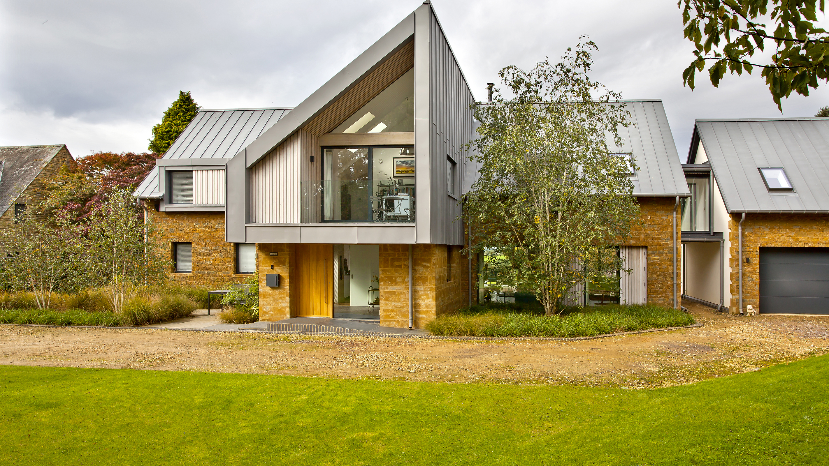 self build house with zinc roof and balcony