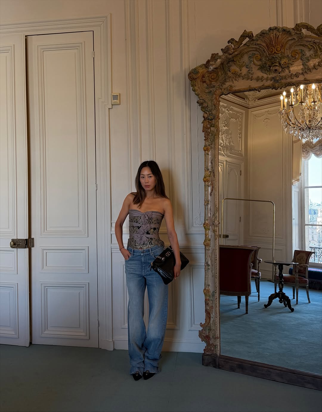 An image of a woman wearing sun faded jeans, a major denim trend 2026.