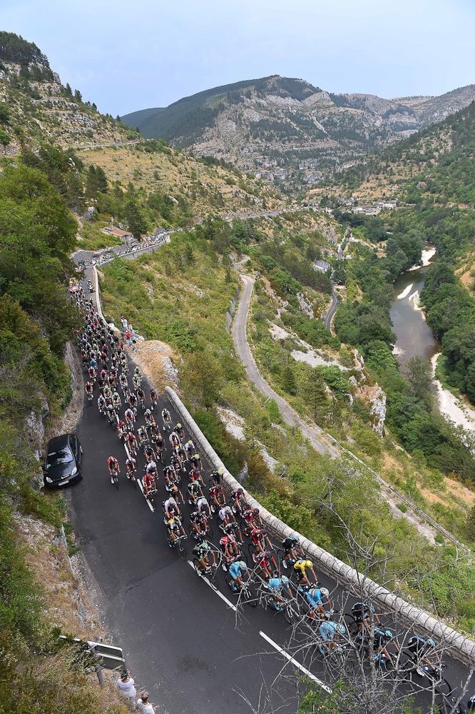 The peloton rolls through the French countryside during stage 14.