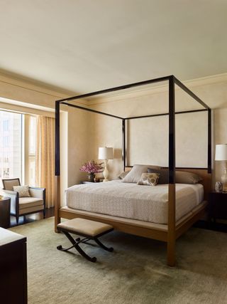 neutral bedroom with simple modern four poster bed