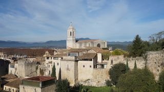 Buildings of Girona with mountains in background