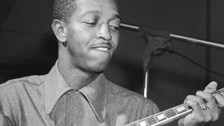 American jazz guitarist Freddie Green (1911-1987) plays an acoustic guitar in a recording studio