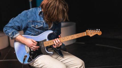 A guitarist plays Fender's 70th Anniversary Ultra Stratocaster HSS guitar