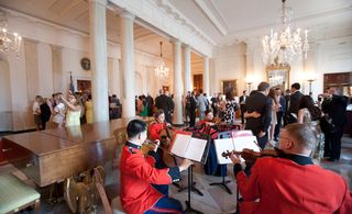 A string quartet from 'The President's Own' U.S. Marine Band welcomed winners and guests to the state floor entrance hall, where Simmie Knox's 2011 painting of President Bill Clinton proved a popular photo op