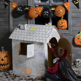 Kids with wooden wall and haunted house