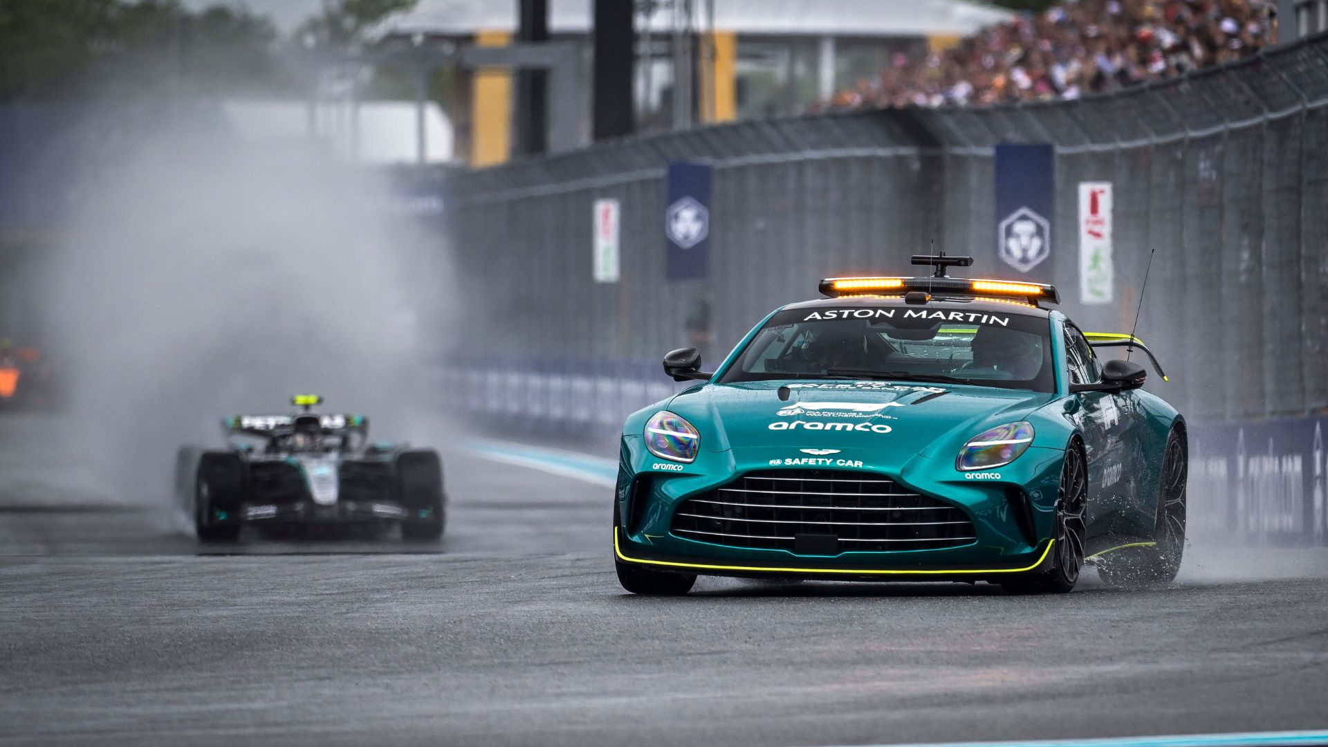 an image of a teal blue Porsche in a racing track being driven by Bernd