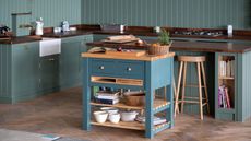 Teal freestanding harvest table with multiple storage solutions
