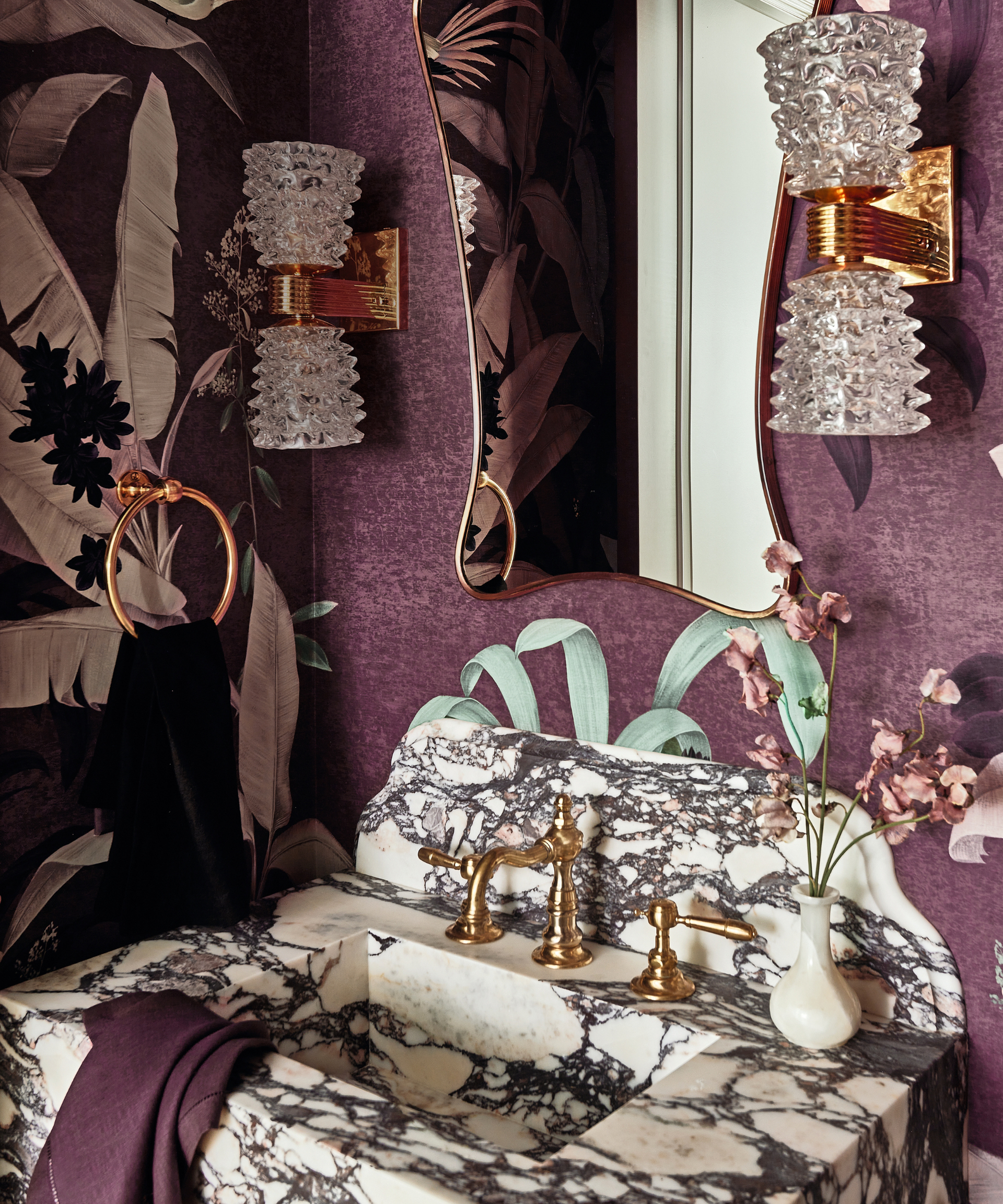 W/C with marble washstand, art deco mirror and wall lights and purple nature inspired wallpaper