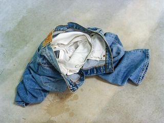 Two pairs of crumpled jeans and some underwear that seem to have been discarded in a steamy rendezvous.