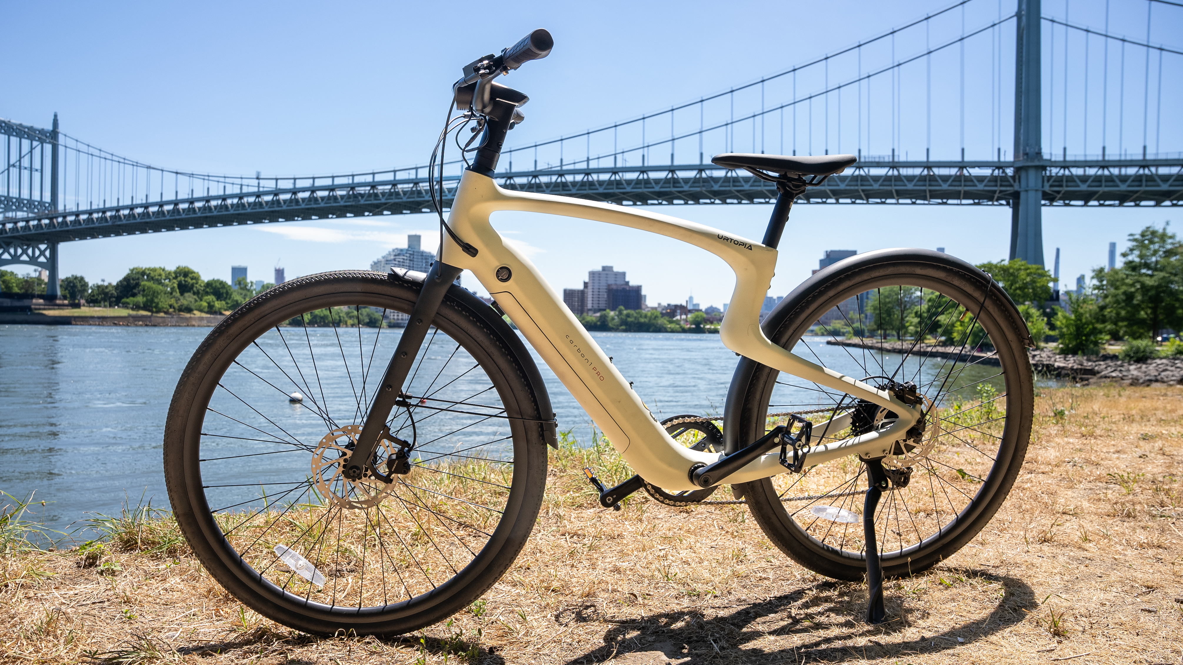 Urtopia Carbon 1 Pro electric bike parked in front of a bridge