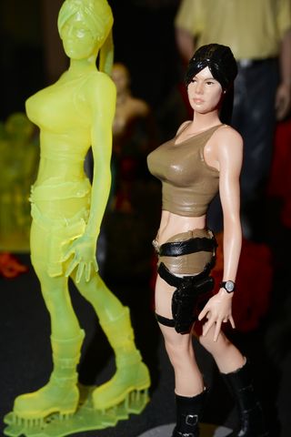 Laura Croft straight from the MoonRay resin printer (left) and a smaller painted version.