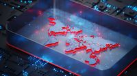 A CGI representation of cyber attacks and identity attacks shown as a glowing world map set against a futuristic circuitboard.