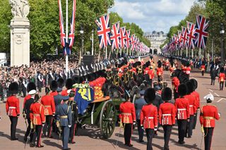 The Queen’s funeral cortege makes its way along The Mall from Buckingham Palace during the procession for the Lying-in State of Queen Elizabeth II on September 14, 2022 in London, England
