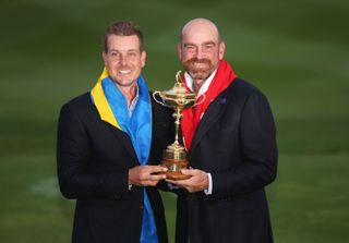 Henrik Stenson and Thomas Bjorn smile with the Ryder Cup trophy