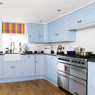 kitchen area with blue cabinets and worktop