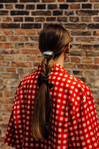 Street style photo during Copenhagen Fashion Week of a woman wearing a ponytail cuff