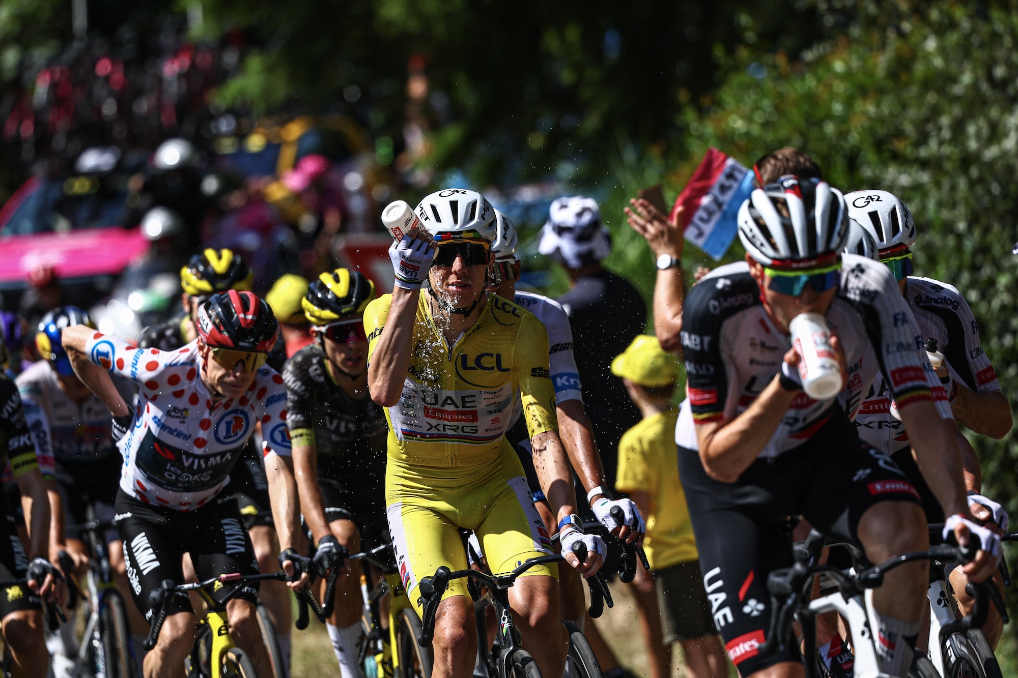 UAE Team Emirates - XRG's Slovenian rider Tadej Pogacar wearing the overall leader's yellow jersey douses himself with water to cool down, stage 9, Tour de France