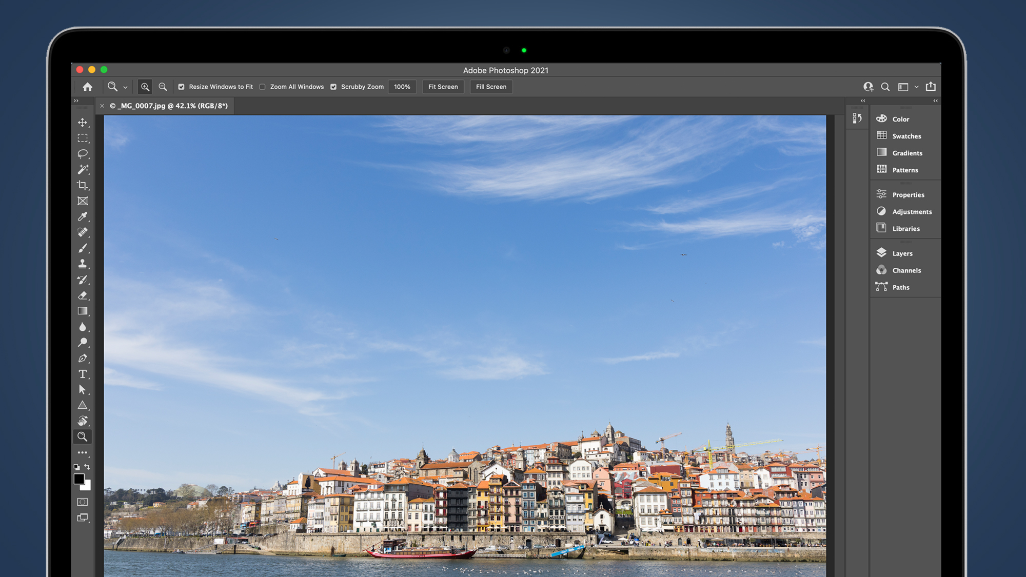 Photo of a town by the sea on a laptop screen