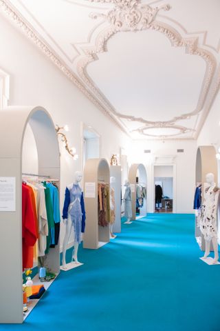 Inside of Camera Nazionale della Moda Italiana fashion hub with clothes hanging in light-filled space