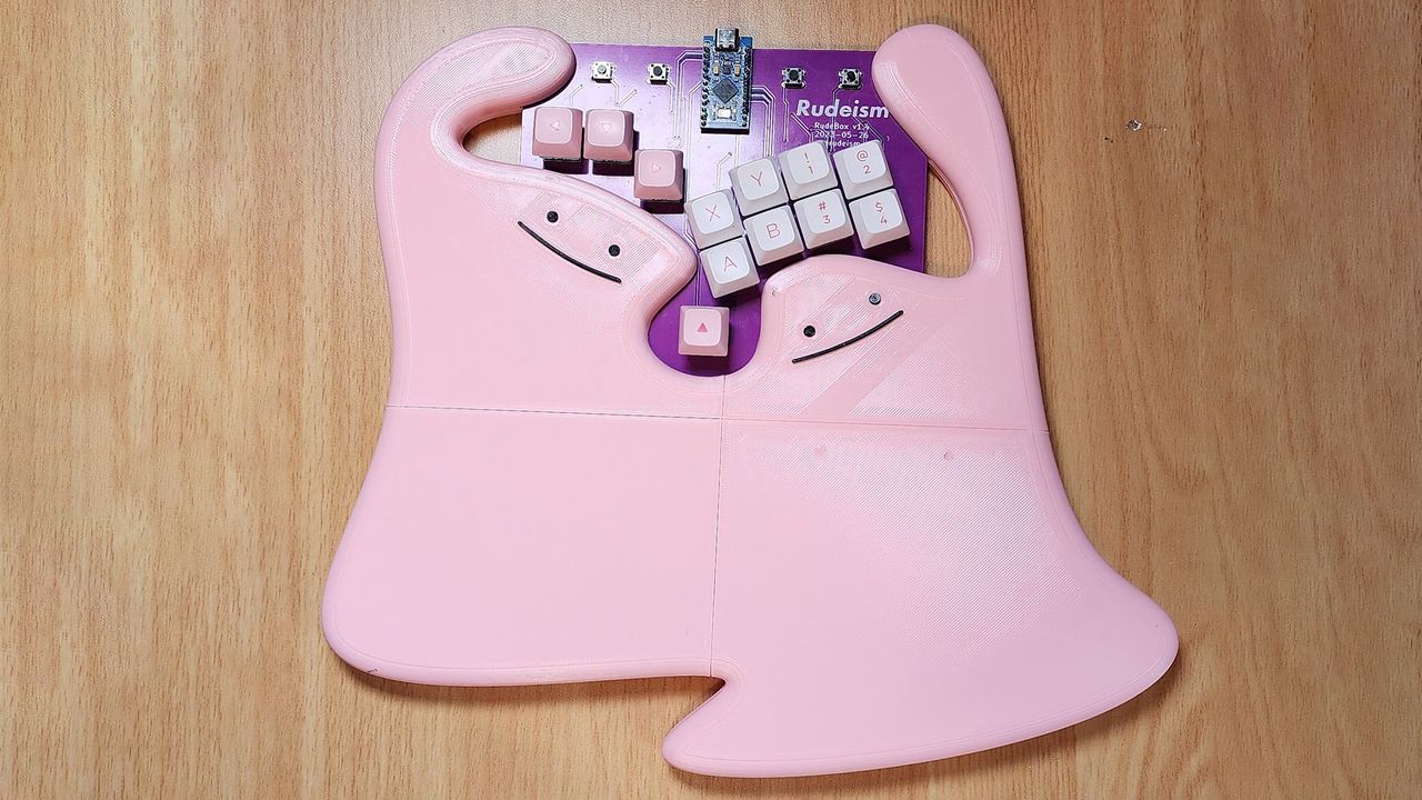 Rudeism's Rudebox custom fighting pad on a desk with wrist rest depicting two dittos