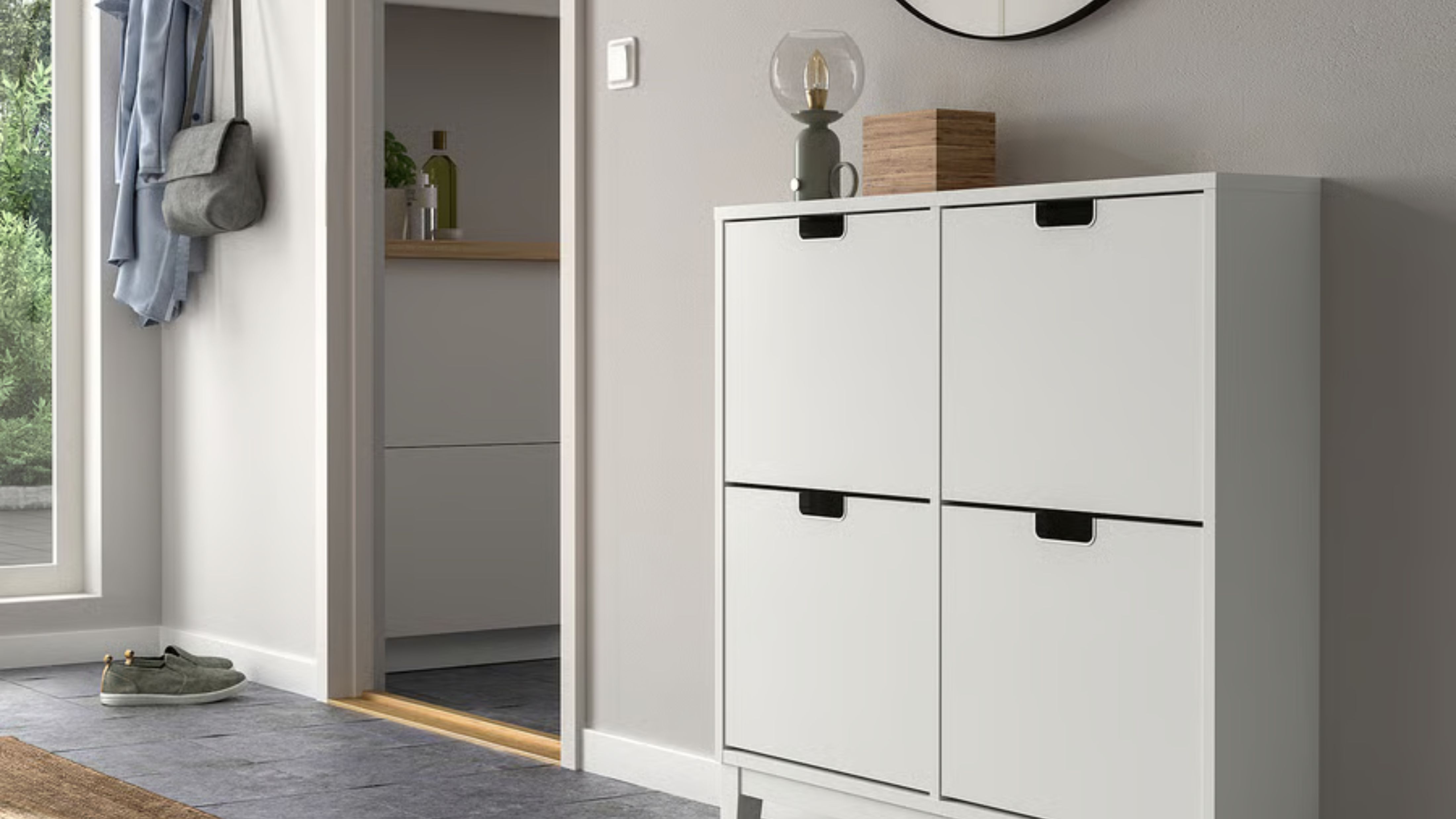 White minimalist IKEA shoe storage cabinet styled inside of a light gray entryway area