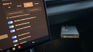 a floppy drive attached to a Tesla via the glove box USB port