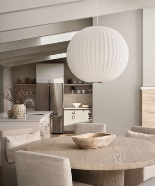 A minimalistic kitchen with a spherical white light fixture