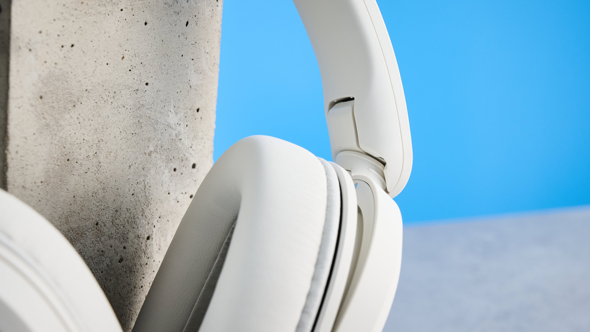 Sony WH-CH730N in white photographed in front of a blue background