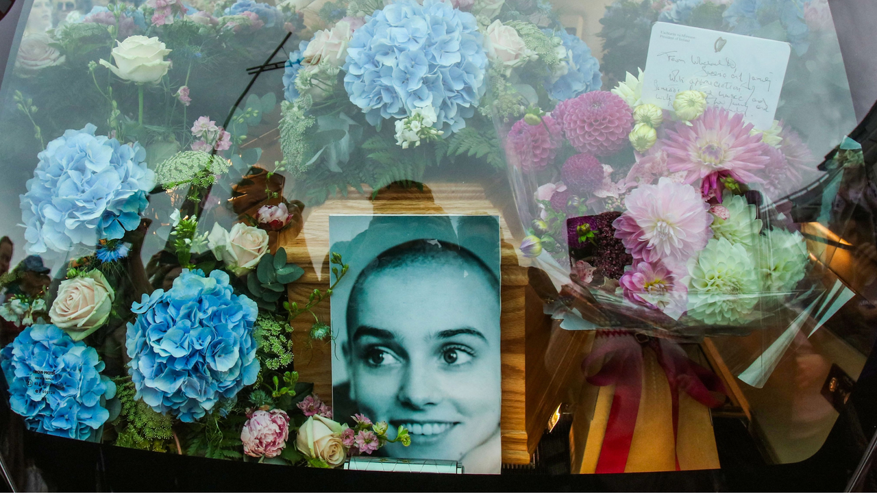 A photograph taken on August 8, 2023 shows the coffin and a picture of late Irish singer Sinead O&#039;Connor, in the hearse during her funeral procession outside her former home in Bray, eastern Ireland, ahead of her funeral on August 8, 2023. A funeral service for Sinead O&#039;Connor, the outspoken singer who rose to international fame in the 1990s, is to be held on Tuesday in the Irish seaside town of Bray.