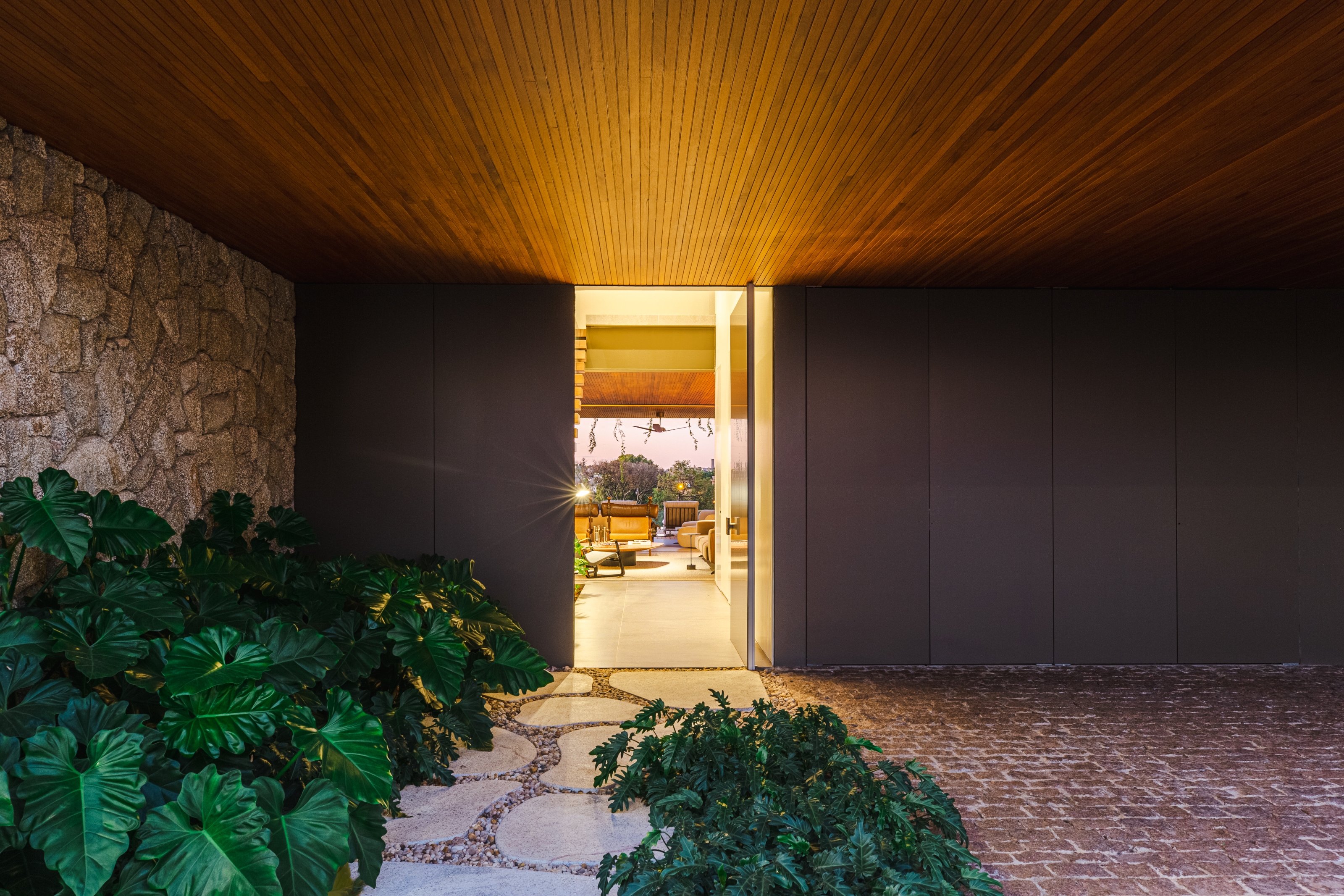 The front door adjoins the carport